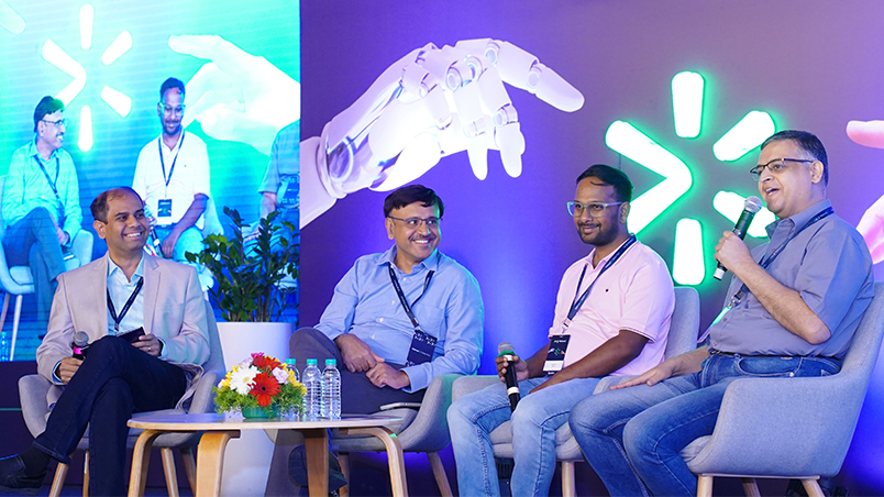 A panel discussion on stage, featuring renowned technology leaders across industries.