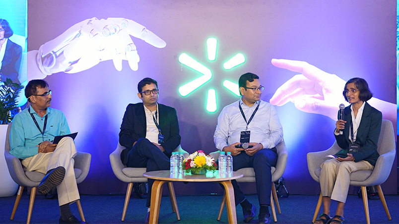 A panel discussion on stage, featuring renowned technology leaders and academicians. 