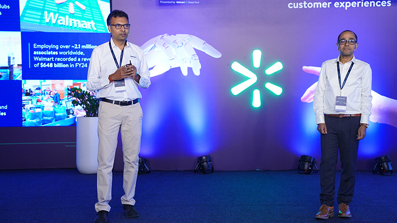 Walmart Global Tech’s Nataraju Vusirikala and Subhasish Misra delivering a presentation on stage. 