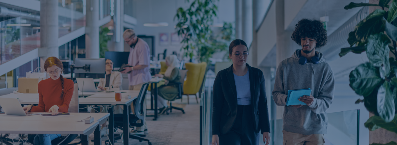 Five people working in an office. There are three women and two men